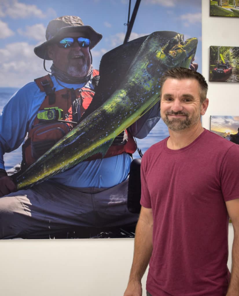 Luther Cifers with photo of a man holding a big fish